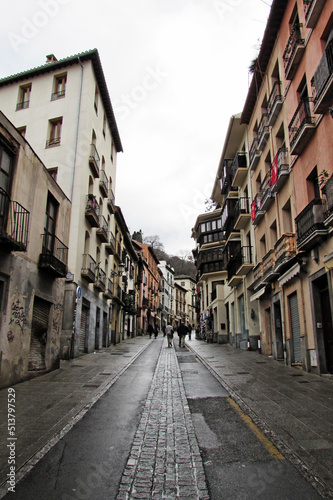 Fototapeta Naklejka Na Ścianę i Meble -  Walking along the Cuesta de Gomerez in Granada during a rainy day.