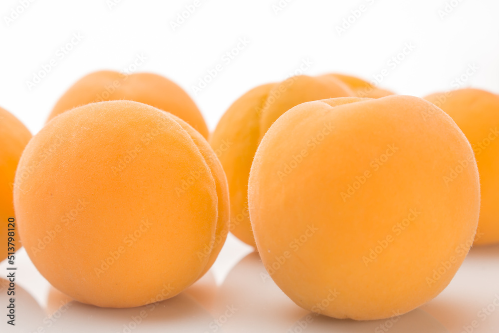 Yellow ripe apricots on a white background Yellow ripe apricots on a white background
