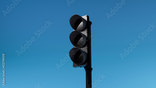 not working or turned off triple black traffic light isolated on blue sky background. Mock-up or source. 3d render