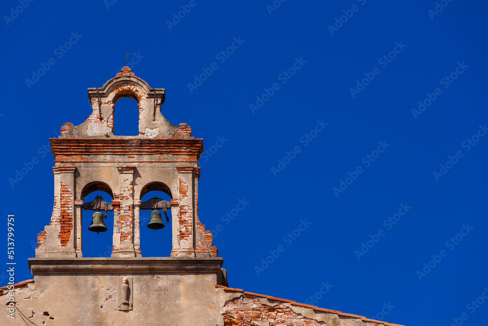 Religious architecture in Pisa. Ruins of an ancient belfry (with blue sky and copy space)