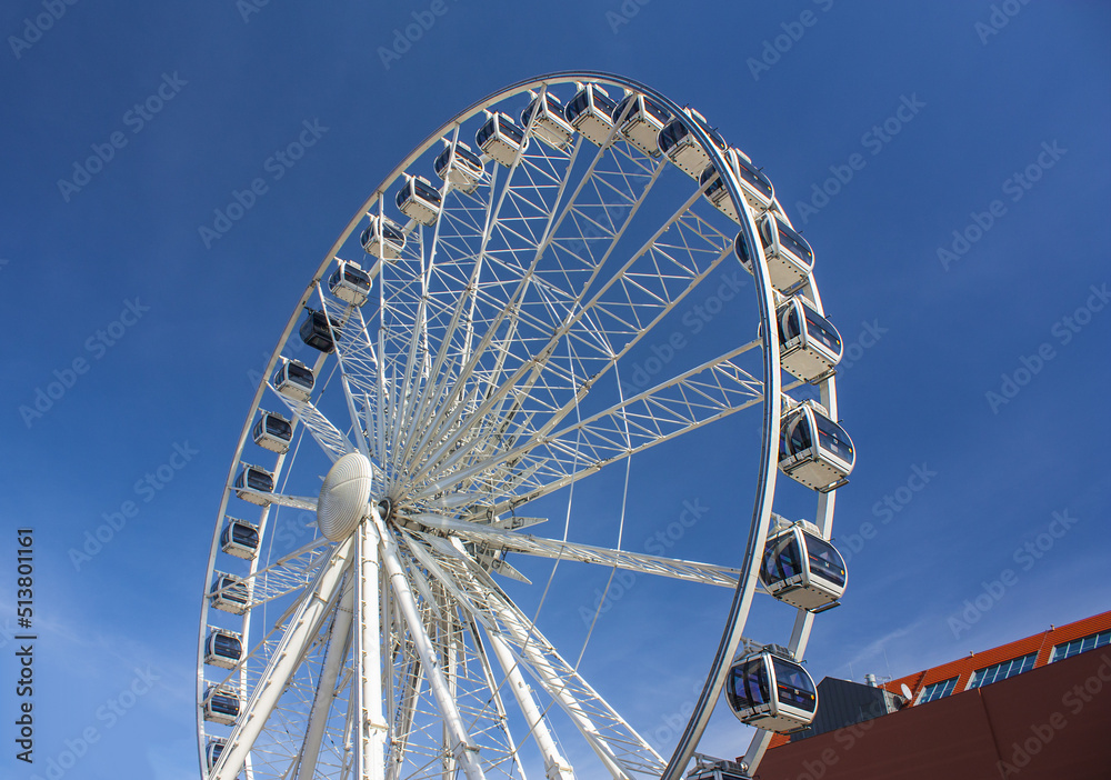 Ferris wheel (AmberSky)over blue sky in Gdansk, Poland