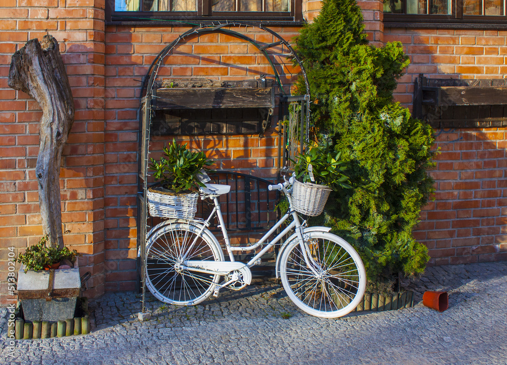 White bike standing on a place next to the restaurant at old town in Gdansk, Poland