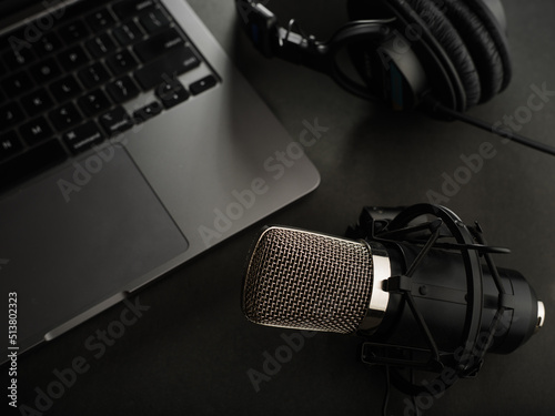 Professional studio equipment - headphones, microphone, laptop. Sound work, singing, journalism, podcast, blogging, announcer, radio. Banner, advertising.