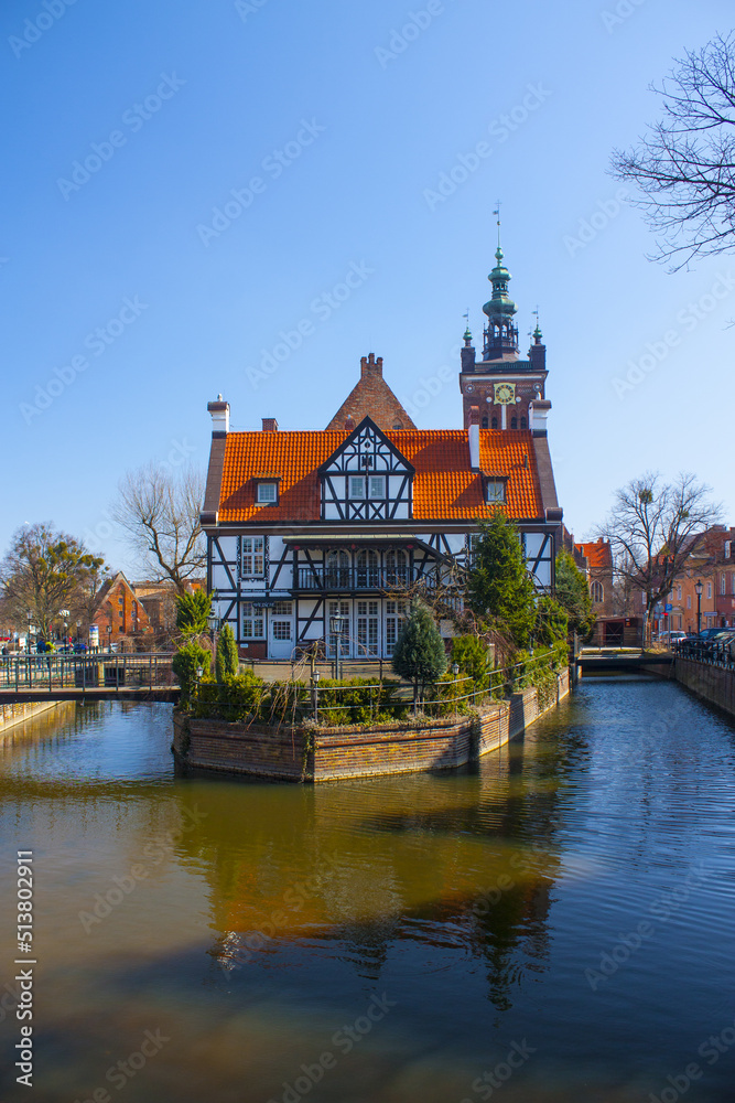 Picturesque scenery of half-timbered building on the river island near Great Mill (Dwor Mlynarzy) in Old Town of Gdansk, Poland	
