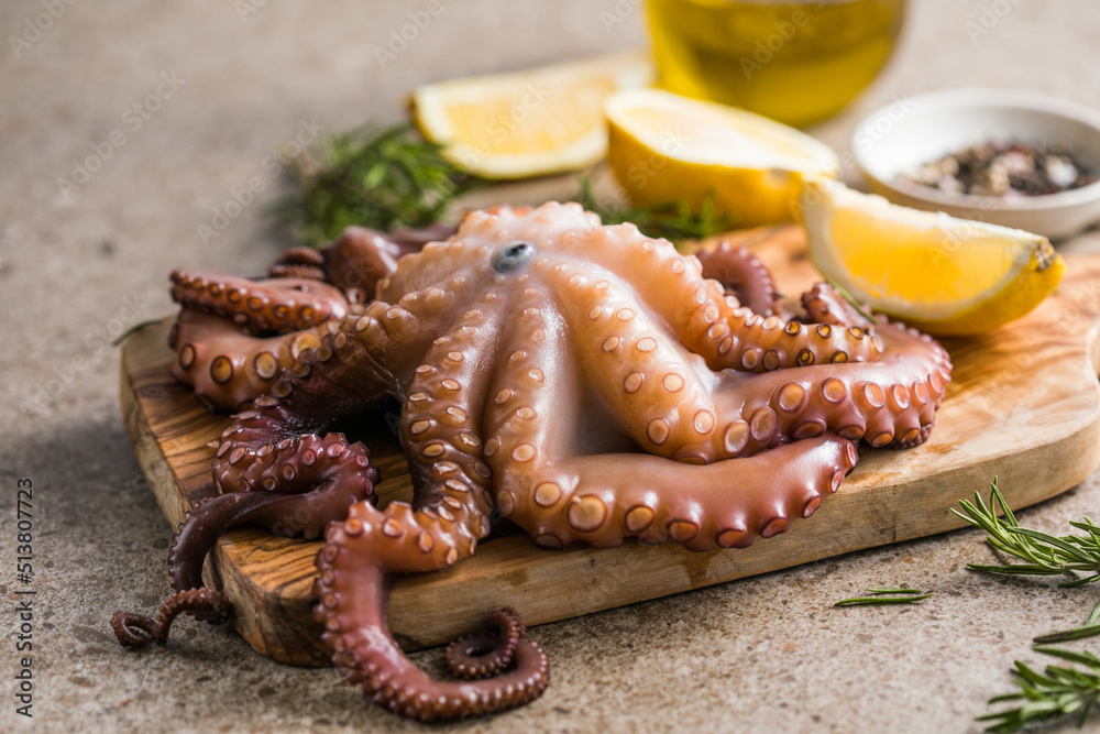 Octopus cooked with chopped herbs served on a board Octopus cooked with chopped herbs served on a board