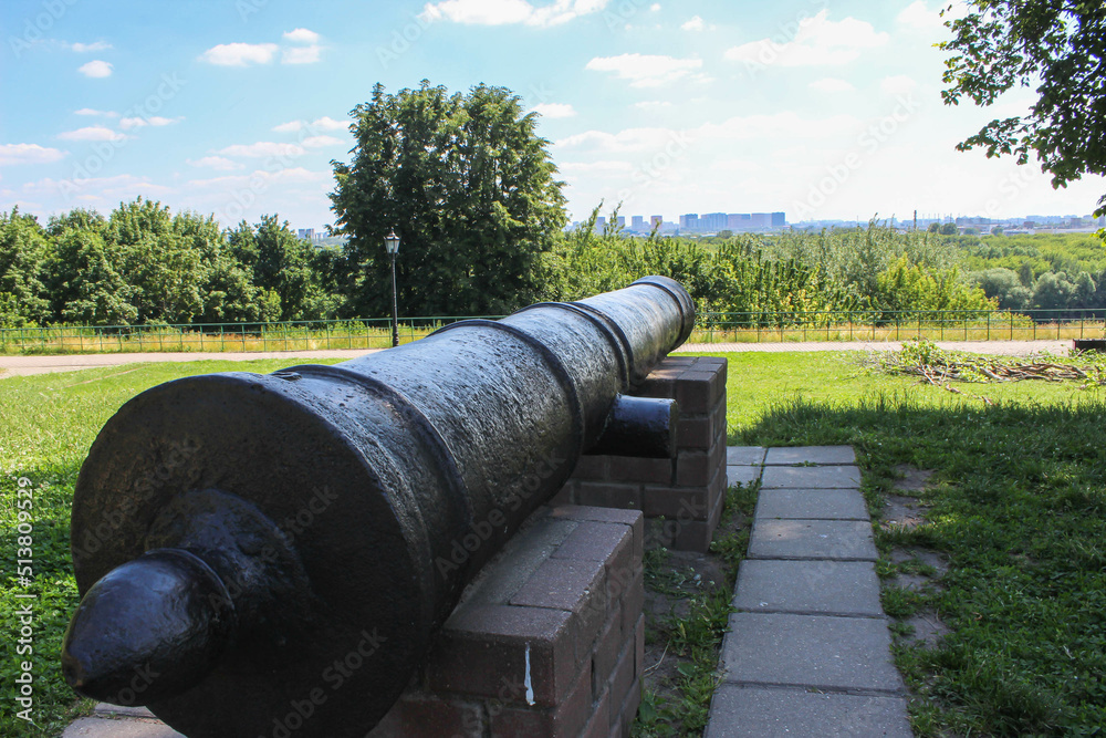 The barrel of an artillery gun standing on brick pedestals The barrel of an artillery gun standing on brick pedestals