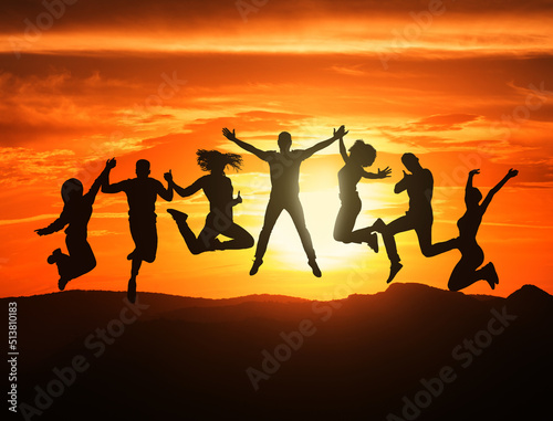 Group Of Black Figures Of Joyful Young People Jumping Together On Sunset