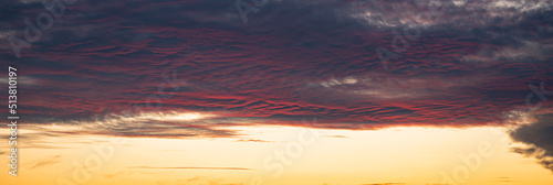 Ripples and small waves in altocumulus clouds are coloring purple and pink after sunset