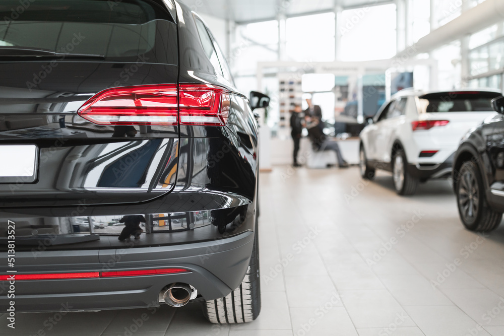 Fototapeta premium Automotive industry, transportation. Closeup of brand new luxury car at modern automobile dealership salon, empty space