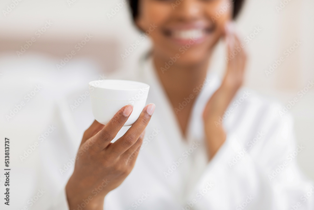 Skin Care Cosmetics. Smiling Black Woman Holding Jar With Moisturising Cream Skin Care Cosmetics. Smiling Black Woman Holding Jar With Moisturising Cream