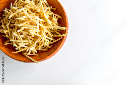 Bilde på lerret straw potatos chips in a bowl on white background.