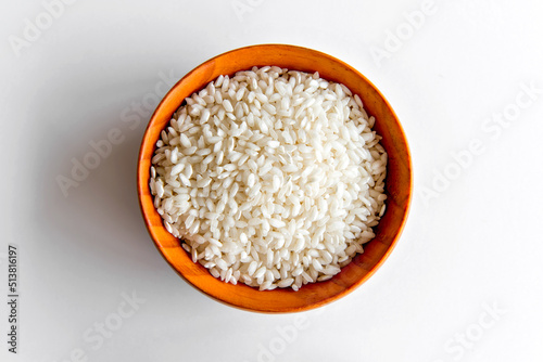 Arboreal rice in bowl, risotto rice in white background. photo
