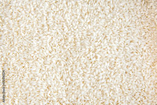 Arborio rice or risotto rice texture background top view.