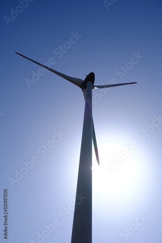 Wind turbines are alternative electricity sources, the concept of sustainable resources, Beautiful sky with wind generators turbines, and Renewable energy. Backlighting windmill. © AliRza