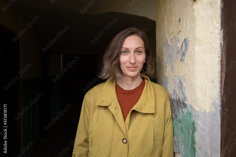 Fototapeta premium young caucasian smiling woman with short hair standing alone at corridor