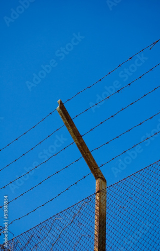 Barbed wire silhouette against sky.
