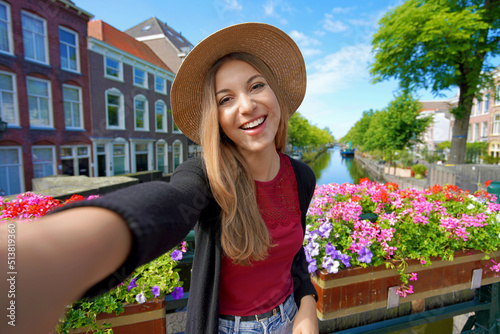 Photography Tourist girl taking self portrait on canal in The Hague, Netherlands