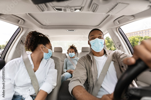 African American Family Sitting In Car, Wearing Face Mask