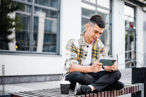 Student guy playing on the phone