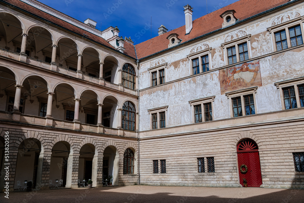 Litomysl, Czech Republic, 17 April 2022: Renaissance aristocratic castle, UNESCO World Heritage Site, chateau with sgraffito mural decorated plaster at facade at sunny day, courtyard with arcades