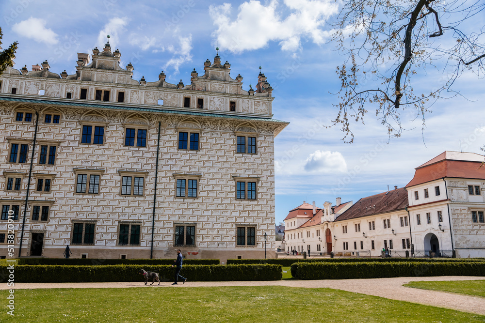 Litomysl, Czech Republic, 17 April 2022: Renaissance castle, UNESCO World Heritage Site, chateau with sgraffito mural decorated plaster at facade at sunny day, medieval historical town with park