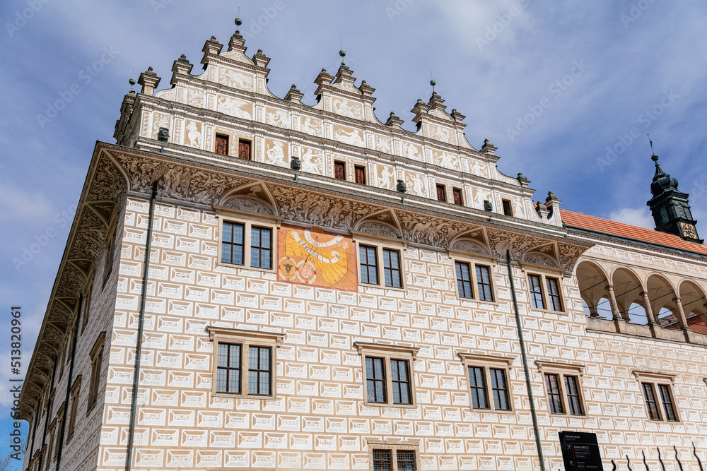 Litomysl, Czech Republic, 17 April 2022: Renaissance castle, UNESCO World Heritage Site, chateau with sgraffito mural decorated plaster at facade at sunny day, medieval historical town, sundial