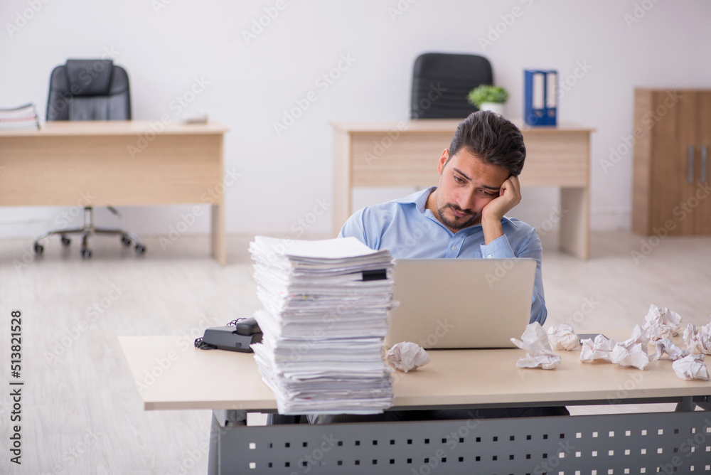 Young male employee rejecting new ideas in the office Young male employee rejecting new ideas in the office