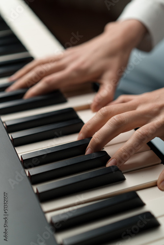 Photography refined woman pianist plays the piano with thin fingers, sensually plays a music