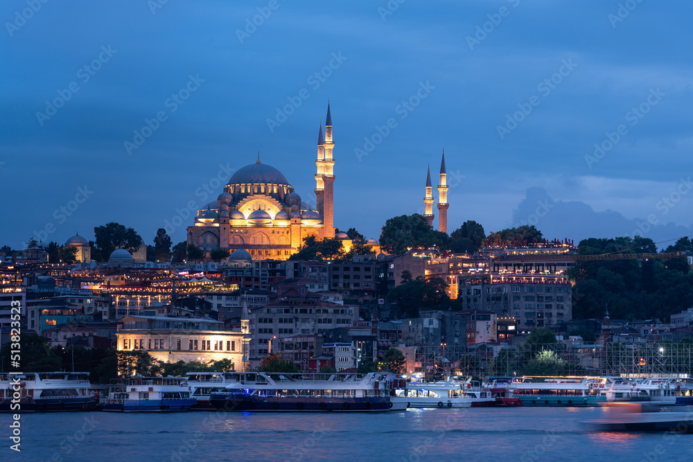 Naklejka premium Suleymaniye Mosque with night illumination and minaret of Rustem Pasha Mosque, Istanbul, Turkey