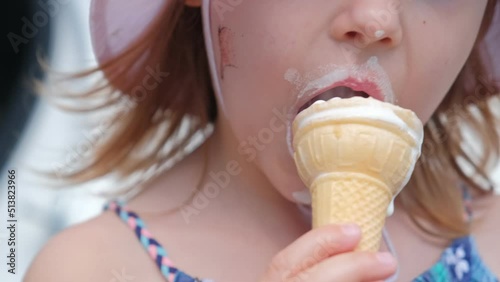 Young Adorable Caucasian Girl Eating Sweet Melting Vanilla Ice Cream on Hot Summer Day Getting Her Face Dirty