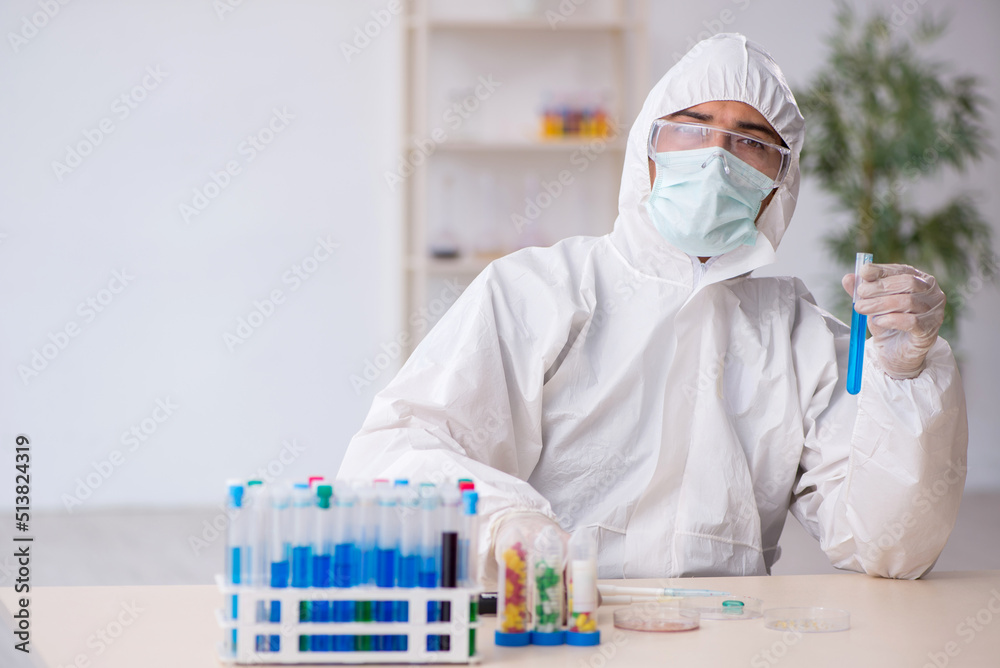 Young male chemist in drugs synthesis concept Young male chemist in drugs synthesis concept