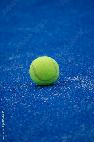 selective focus, one ball on a blue artificial grass paddle tennis court