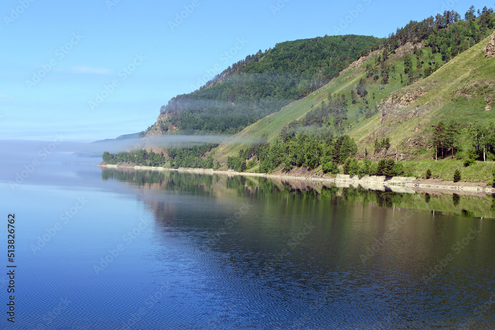 Lake Baikal in summer. Landscape with lake, forest and mountains.