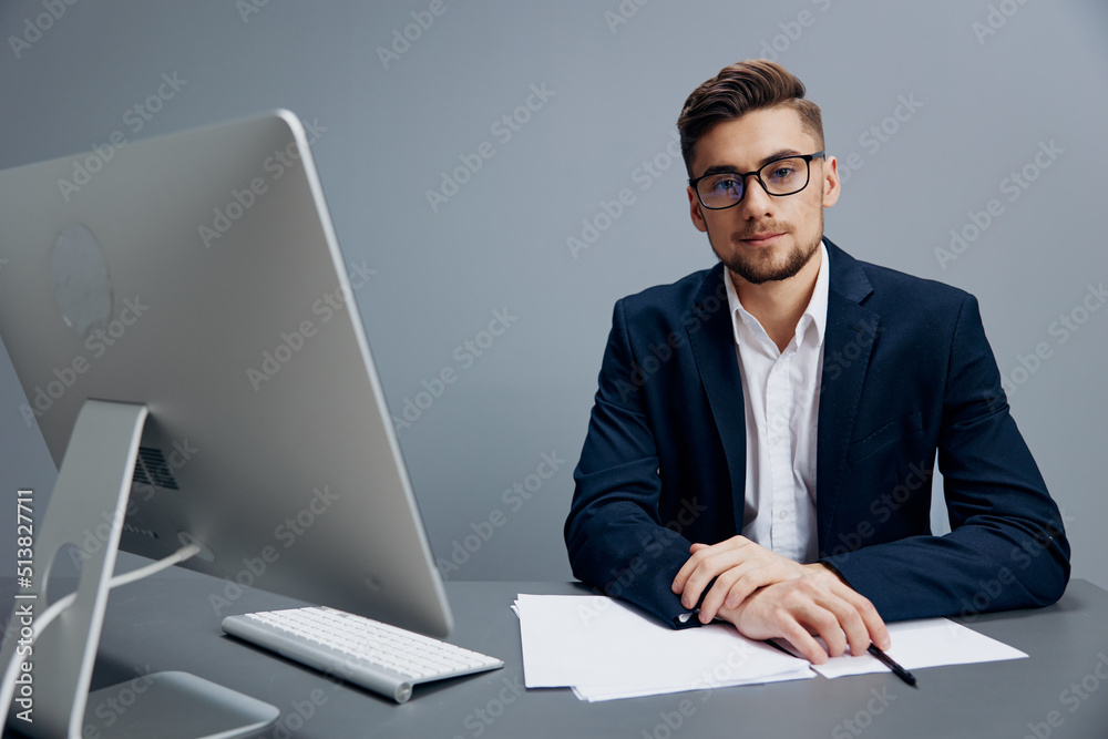 handsome businessman wearing glasses works in front of a computer office handsome businessman wearing glasses works in front of a computer office