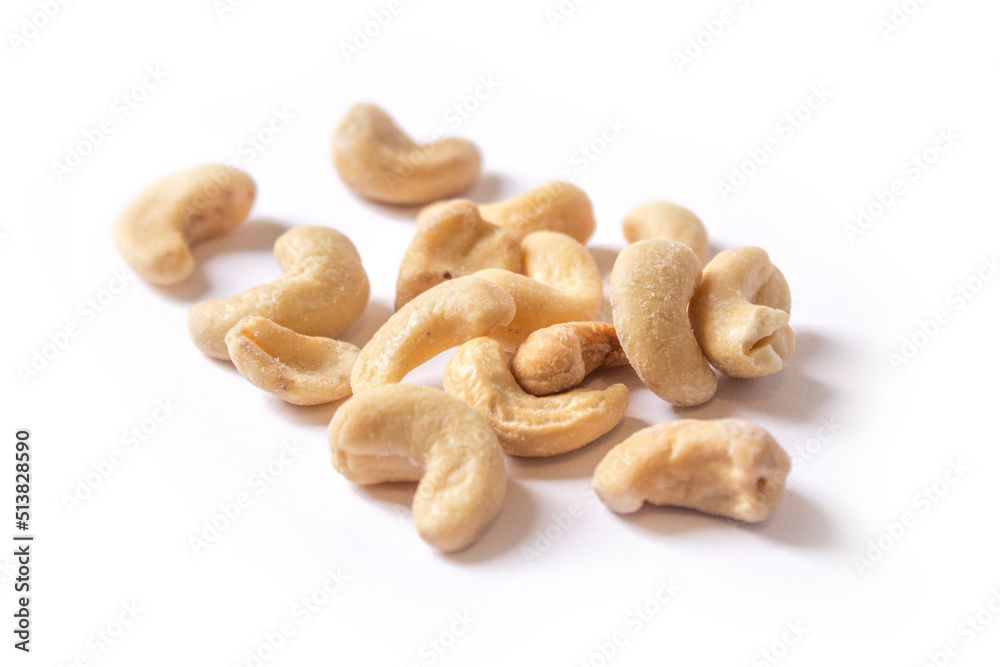cashew nuts lie on a white background cashew nuts lie on a white background