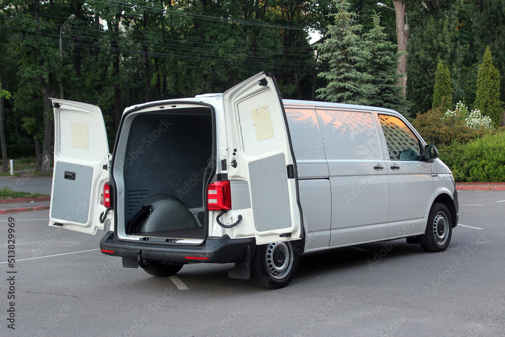 Modern cargo van with open empty trunk. Modern cargo van open trunk. Car boot is open. Modern car with open empty trunk.
