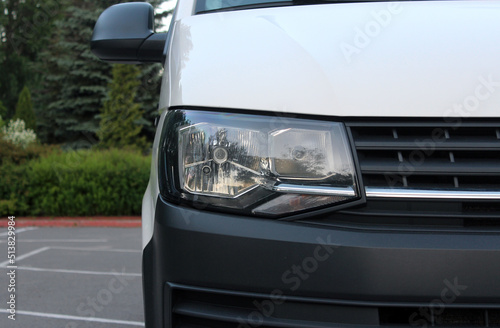 Modern Cargo Van front headlight with headlight washer. Cargo Van light. Modern Car front headlight.