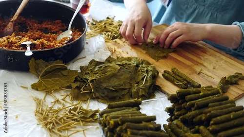 a woman making stuffed leaves, stuffed leaves from Turkish cuisine,