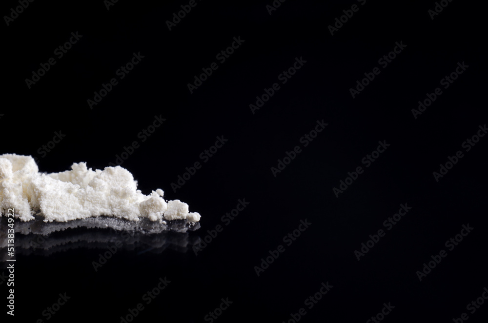 White drug on a black background White drug on a black background