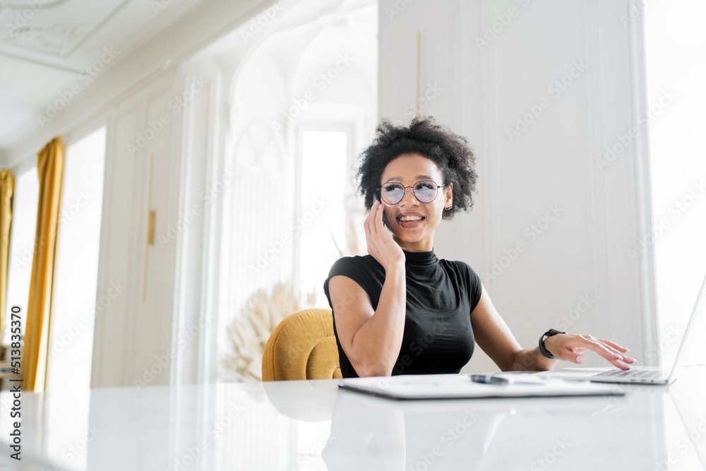 Manager calls on the phone with glasses manager, works in the office uses a laptop, coworking space Manager calls on the phone with glasses manager, works in the office uses a laptop, coworking space