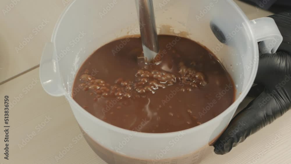 process milk chocolate and cream with an immersion blender to produce a