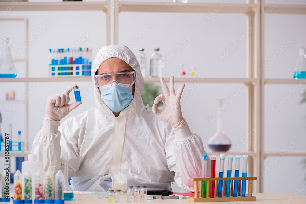 Young male chemist working at the lab during pandemic Young male chemist working at the lab during pandemic