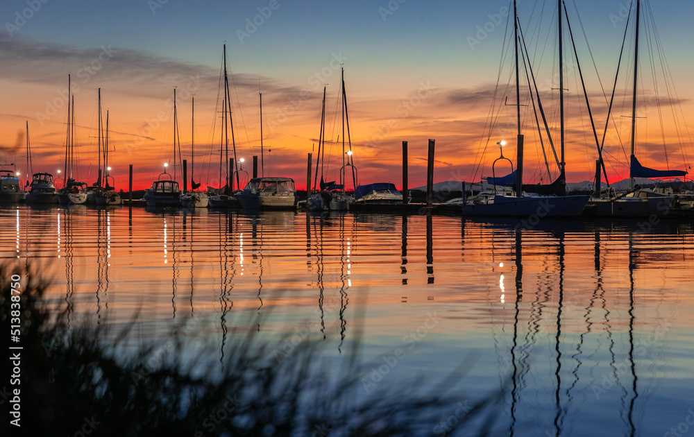 Beautiful sunset at the yacht harbor. Summer sunset at the sea.