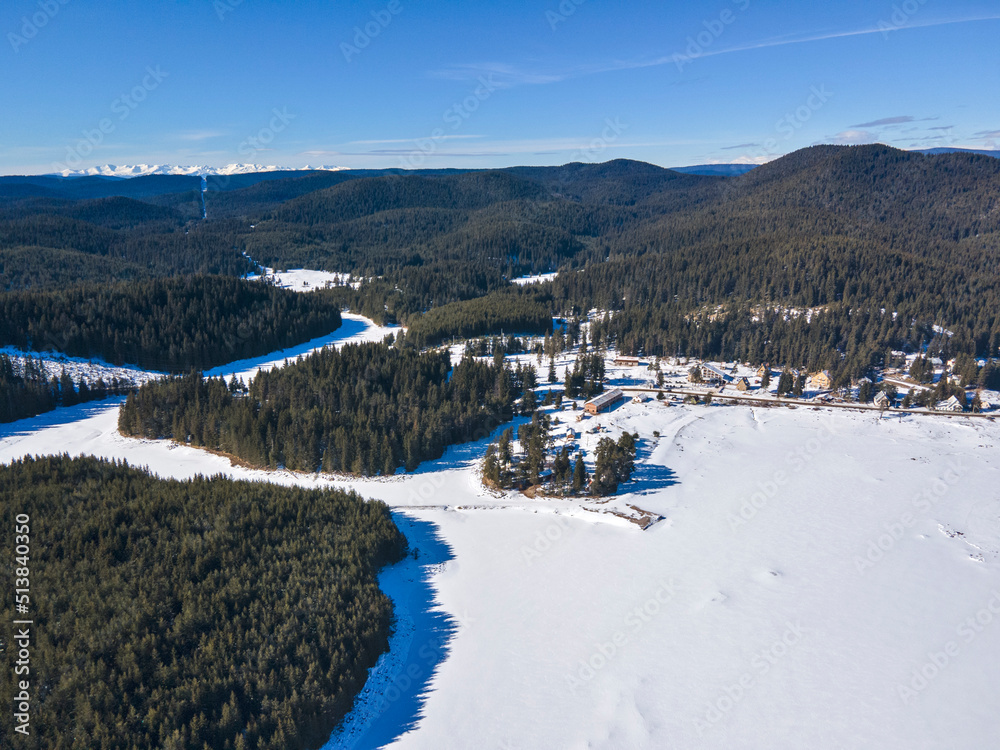 Aerial winter view of Shiroka polyana Reservoir covered with ice,  Bulgaria