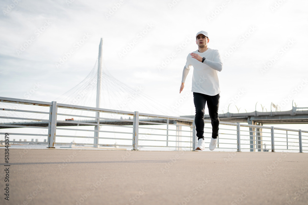 Male athlete active exercise running, in sportswear. Outdoor fitness training
