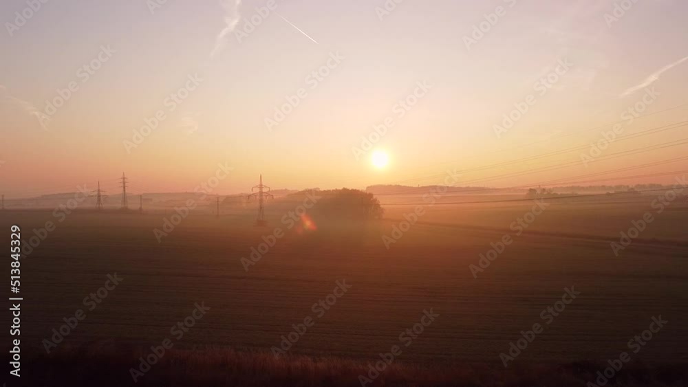 The train rides through the rural countryside in the autumn sunrise. The train rides along the beautiful autumn field in nature. The train rides through the rural countryside in the autumn sunrise. The train rides along the beautiful autumn field in nature.