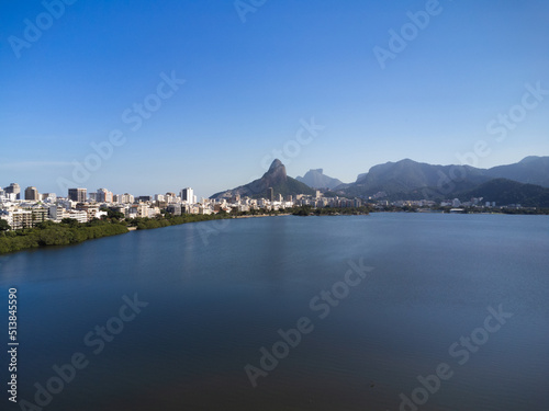 Aerial view of Rodrigo de Freitas Lagoon, south zone of Rio de Janeiro, Brazil. In the background, the beaches of Ipanema and Leblon and Morro Dois Irmãos. Sunny day. Buildings around. Drone photo