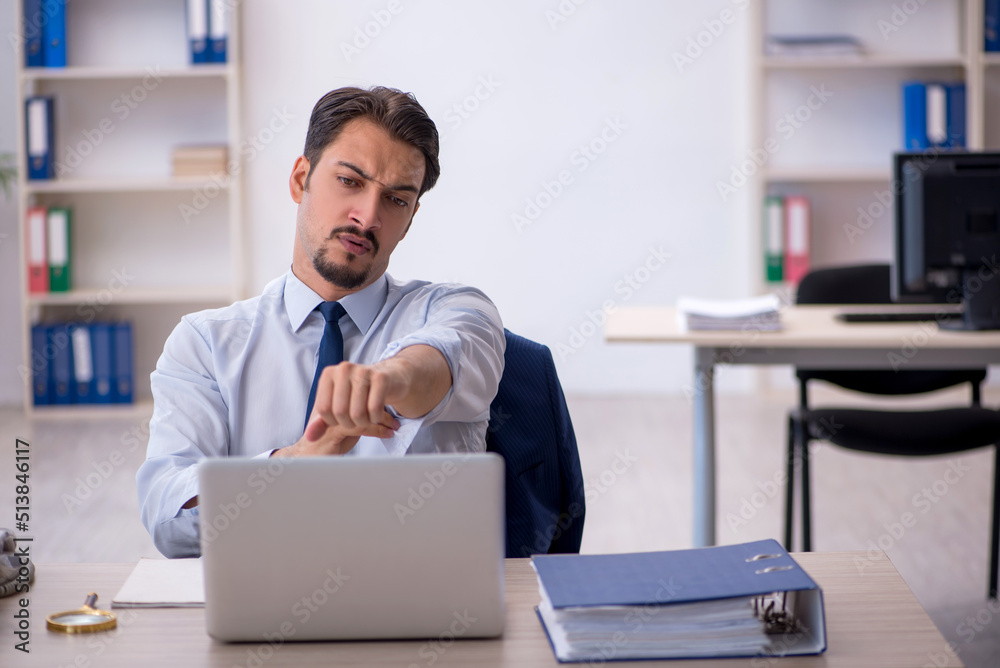 Young male employee working in the office Young male employee working in the office