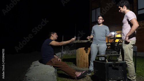 friends smoking marijuana in a country house next to grills and chinese boxes in the highlands at night