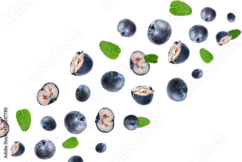 Tasty ripe blueberries with green leaves flying on white background